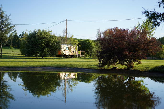 view of Rozanne roulotte across the pond at Coutillard in France 