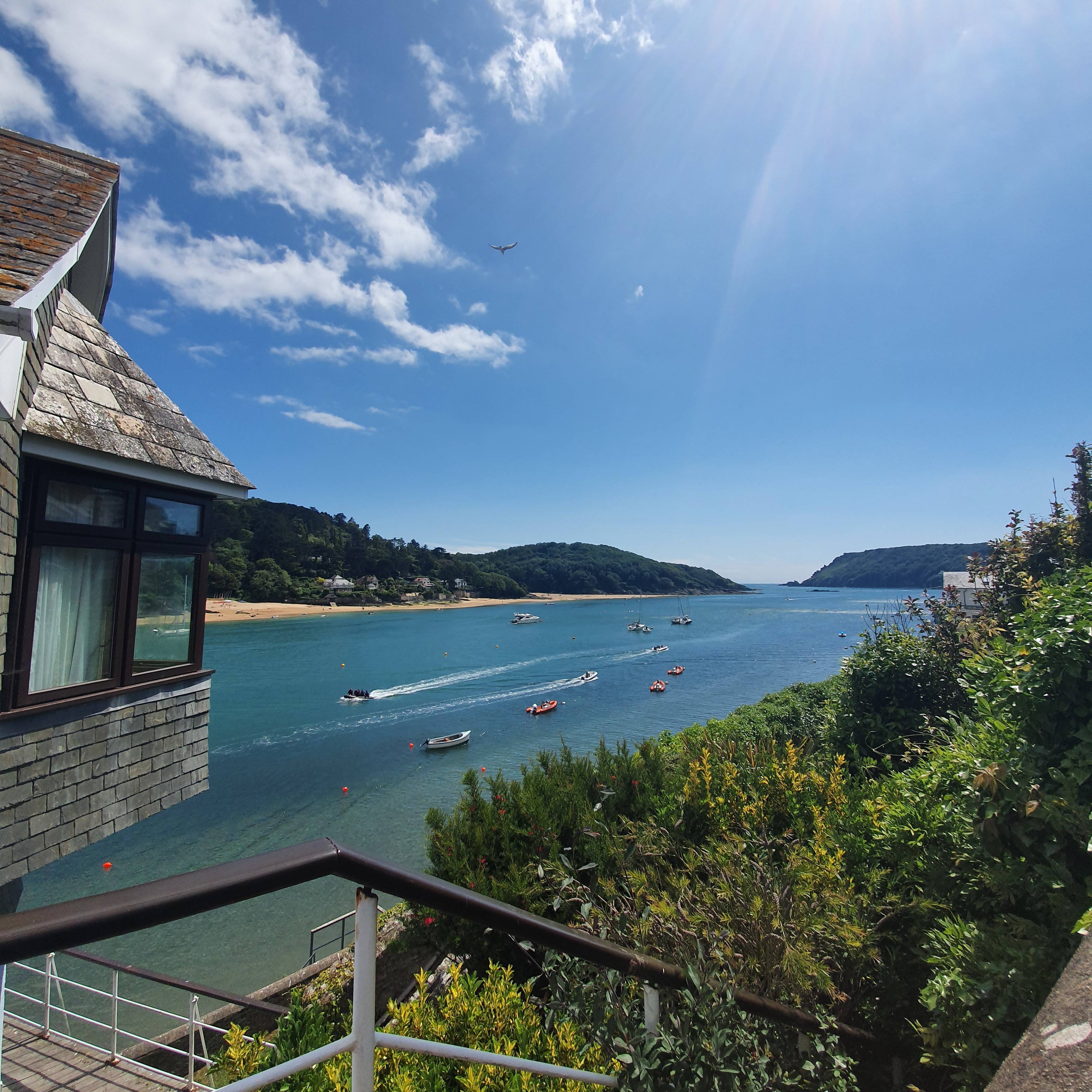 View past the edge of a house to the bay at Salcombe